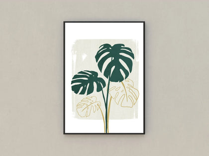 Framed hanging from a beige wall sits a print by Demi Yuill of a Monstera Cheese Plant with golden highlighted leaves
