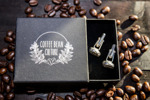 surrounded by coffee beans sits in a jewellery box two sterling silver coffee bean cuff links
