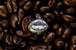 surrounded by coffee beans sits a sterling silver coffee bean cuff link