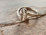 Resting on a stone slate sits a sterling silver coffee bean ring