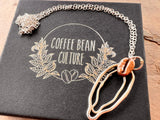 Sterling silver vulva necklace with red bronze coffee bean
