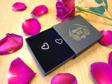 boxed up surrounded by roses are sterling silver heart shaped earrings