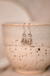 hung from the hooks are a pair of sterling silver coffee bean drop earrings